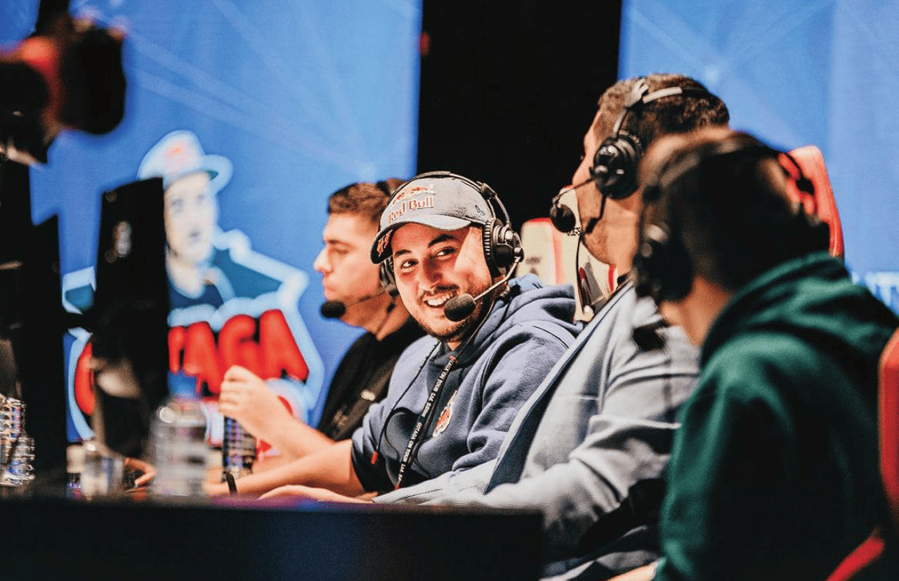 Gotaga assit sur une chaise devant un ordinateur entourré d'autres joueurs